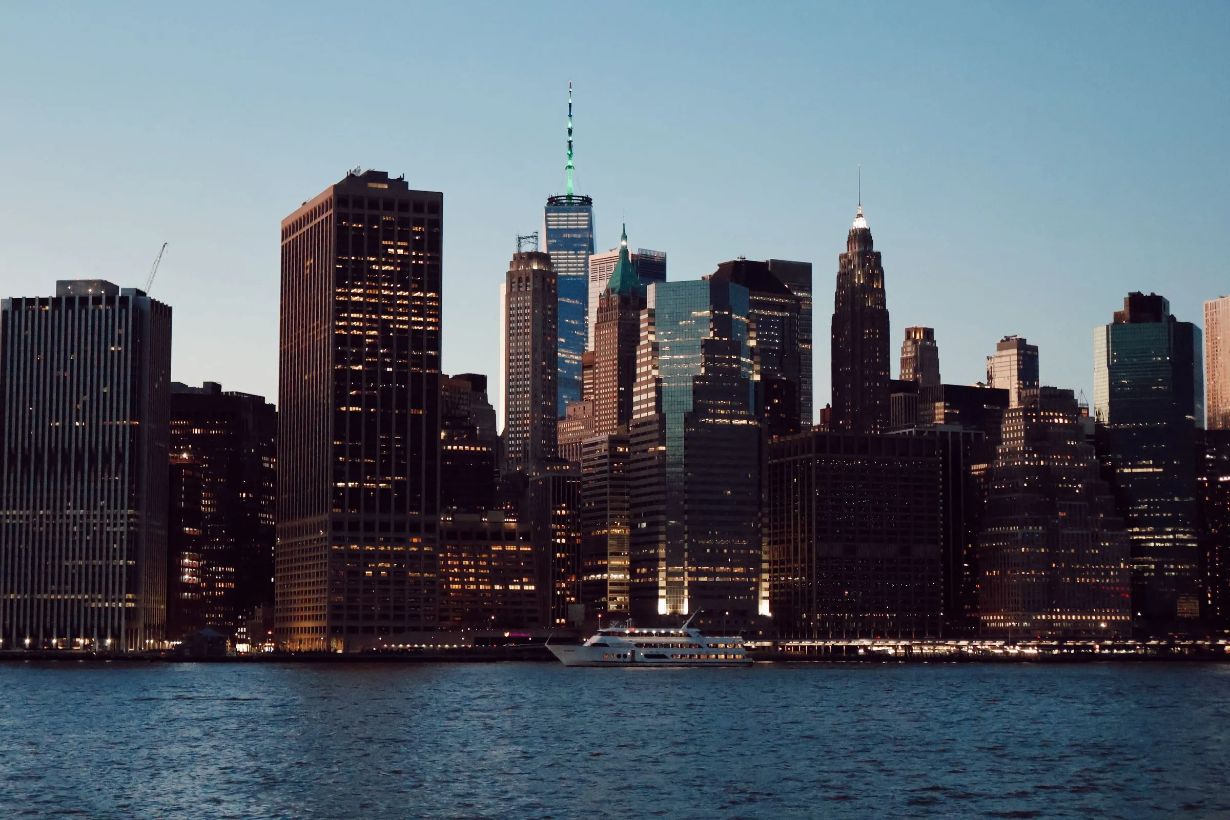 Lower Manhattan skyline viewed across the East River at blue hour